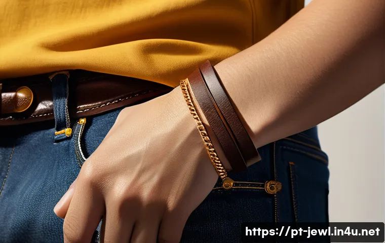 가죽 팔찌와 골드 체인 매치 - A close-up of a stylish wrist adorned with a dark brown natural leather bracelet paired with a thin,...